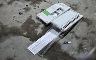 epa11288369 Broken Electronic Voting Machines (EVM) and VVPAT vending machines (an independent printing system connected to the electronic voting machines) lays on the ground after it was destroyed by a mob alleging that there is proxy voting at the polling station at Khurai of Imphal east district, Manipur, India, 19 April 2024. Voting for the general elections in India has begun. The elections are held over seven phases between 19 April and 01 June 2024, and results will be announced on 04 June 2024.  EPA/Robinson Wahengbam