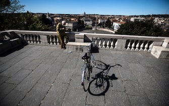A man on a bicycle on the terrace of the Pincio in the park of Villa Borghese during the new lockdown for emergency of the Coronavirus Covid-19 pandemic in Rome, Italy, 15 March 2021. ANSA/ANGELO CARCONI