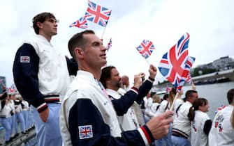 PARIS, FRANCE - JULY 26: Andy Murray of Team Great Britain  waves a flag during the opening ceremony of the Olympic Games Paris 2024 on July 26, 2024 in Paris, France. (Photo by Naomi Baker / POOL / AFP) (Photo by NAOMI BAKER/POOL/AFP via Getty Images)