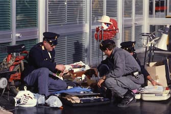 ROME, ITALY, DECEMBER 27, 1985 - Fiumicino Airport (Rome), On 12/27/1985 the Palestinian terroristic group Abu Nidal assaulted simultaneously the airports of Rome and Vienna, Around 9.15 AM, 4 terrorists opened fire with machine gun bursts on passengers queuing for baggage check-in at the counters of the Israeli national airline El Al and the American TWA at Roma-Fiumicino airport, In the attack, 13 people were killed and 76 wounded, 3 of the Palestinian terrorists were killed by Israeli security agents and the commando leader Mohammed Sharam was captured alive by the Italian police, A few minutes after the attack in Italy, the attack in Vienna airport broke out, causing 3 deaths and 44 injuries, In this picture the Italian police investigating. (Photo by Edoardo Fornaciari/Getty Images)
