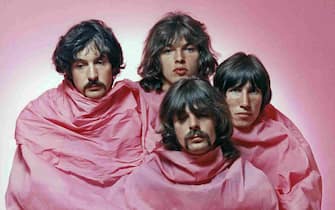LOS ANGELES - AUGUST 1968: Psychedelic rock group Pink Floyd pose for a portrait shrouded in pink in August of 1968 in Los Angeles. (L-R) Nick Mason, Dave Gilmour, Rick Wright (center front), Roger Waters. (Photo by Michael Ochs Archives/Getty Images)