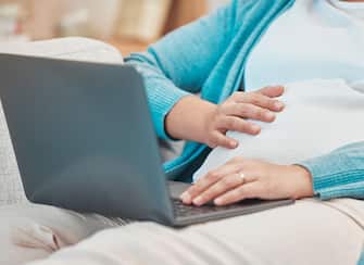 Pregnant, woman and laptop for online medical research to prepare for motherhood and being a parent. Computer, mum and pregnancy with a female