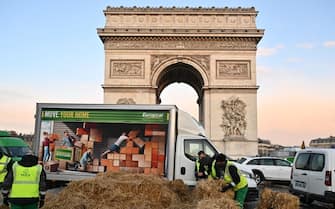 PARIS, FRANCE - MARCH 01: City workers clear the road in front of the Arc de Triomphe on the Champs-Elysees after a protest by the French farmers' union in Paris, France on March 1, 2024. (Photo by Mustafa Yalçn/Anadolu via Getty Images)