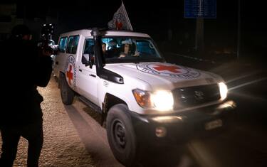 A Red Cross bus vehicle carrying Israeli hostages arrives at Rafah in the southern Gaza Strip on November 30, 2023, amid the release of Palestinian prisoners in exchange for hostages held by Hamas in Gaza since the October 7 attacks. (Photo by AFP)