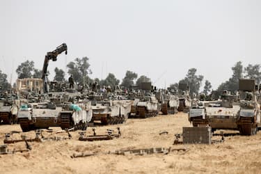 epa11312280 Israeli soldiers with military vehicles gather at a position on the southern Israeli border with the Gaza Strip, near the Palestinian city of Rafah, 01 May 2024. More than 34,300 Palestinians and over 1,455 Israelis have been killed, according to the Palestinian Health Ministry and the Israel Defense Forces (IDF), since Hamas militants launched an attack against Israel from the Gaza Strip on 07 October 2023, and the Israeli operations in Gaza and the West Bank which followed it.  EPA/ATEF SAFADI
