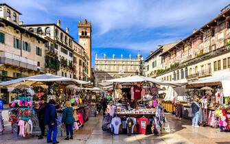 Verona, Italy - November 8: souvenir stands and historic buildings at the old town of Verona on November 8, 2022