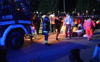 Rescuers assist injured people outside the nightclub 'Lanterna Azzurra' in Corinaldo, near Ancona, central Italy, 08 December 2018. A stampede that occurred overnight outside the nightclub killed six people and injured more than 100, after someone probably caused a panic with a stinging spray. The incident took place at the packed club hosting a concert by popular Italian rapper Sfera Ebbasta. ANSA/ STRINGER
