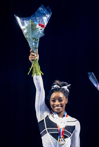 epa10786957 First place Simone Biles (C) reacts with second place Leanne Wong (L) and third place Joscelyn Roberson (R) celebrate during the awards ceremony after the Core Hydration Classic at the NOW Arena in Hoffman Estates, Illinois, USA, 05 August 2023. Biles returned to competition after a two-year break after the Tokyo Olympics.  EPA/ALEX WROBLEWSKI