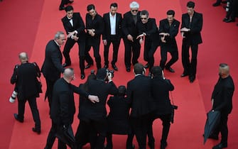 (From L) Spanish actor Manu Rios, Spanish actor Jason Fernandez, US actor and writer, Ethan Hawke, Spanish film director Pedro Almodovar, Italian designer Anthony Vaccarello, Portuguese actor Jose Condessa and actor George Steane arrive for the screening of the film "Extrana Forma de Vida" (Strange Way of Life) during the 76th edition of the Cannes Film Festival in Cannes, southern France, on May 17, 2023. (Photo by Antonin THUILLIER / AFP) (Photo by ANTONIN THUILLIER/AFP via Getty Images)