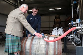 WICK, SCOTLAND - AUGUST 2: King Charles III, with distillery manager Ryan Sutherland, during a visit to the 8 Doors Distillery in John O'Groats, Wick, in the Scottish Highlands, to officially open the distillery and meet members of the local business community on August 2, 2023 in Wick, Scotland. (Photo by Robert MacDonald - Pool/Getty Images)