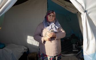 KAHRAMANMARAS, TURKIYE - FEBRUARY 24: Melek Aksu, an earthquake survivor lives the tent city established in Vali Saim Cotur Stadium and around with her partridge named "Boncuk" after 7.7 and 7.6 magnitude earthquakes hit multiple provinces of Turkiye including Kahramanmaras on February 24, 2023. Some survivors of earthquakes in Kahramanmaras live together in a tent city with their animals, such as fish, birds, partridges, cats and dogs, which they rescued while leaving their homes. Established by the Sakarya 7th Commando Brigade Command, the tent city hosts nearly 3,500 earthquake victims as well as dozens of pets. (Photo by Fatih Kurt/Anadolu Agency via Getty Images)