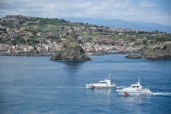 CATANIA, ITALY - APRIL 25: Two patrol boats of the Catania Coast Guard sail in front of the Acitrezza stacks taken from the helicopter during a flight on April 25, 2020 in Catania, Italy. in support of the national health emergency during the Covid19 emergency to ensure the operation of the ports, the safety and regularity of maritime transport and the protection of human life at sea. The Coast Guard works in support of the national health emergency amid the COVID-19 pandemic to ensure the operation of ports, the safety and regularity of maritime transport and the protection of human life at sea as Italy remains on lockdown to halt the spread of Coronavirus.  (Photo by Fabrizio Villa/Getty Images)