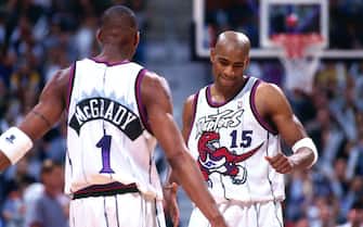 TORONTO - 1999: Tracy McGrady #1 and Vince Carter #15 of the Toronto Raptors look on circa 1999 at the Air Canada Centre in Toronto, Ontario. NOTE TO USER: User expressly acknowledges and agrees that, by downloading and or using this photograph, User is consenting to the terms and conditions of the Getty Images License Agreement. Mandatory Copyright Notice: Copyright 1999 NBAE (Photo by Ron Turenne/NBAE via Getty Images)