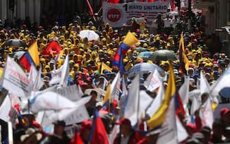 epa11312812 Trade unionists participate in a march on the occasion of International Labor Day, in Quito, Ecuador, 01 May 2024. The Unitary Front of Workers (FUT) of Ecuador and other unions marched to celebrate the victory of the 'No' to legalizing hourly contracts in the referendum called by President Daniel Noboa last 21 April and to protest due to the increase in the value added tax (VAT) decreed by Noboa. Labor Day, or May Day, is observed all over the world on the first day of May to celebrate the economic and social achievements of workers and advocate for their rights.  EPA/JOSE JACOME