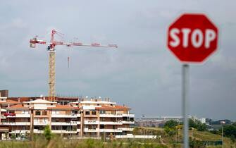 A road traffic 'STOP' signpost is seen standing near to a residential construction site near in Rome, Italy, on Wednesday, May 15, 2013. The Italian government won't need to make more budget cuts this year to finance a plan to ease taxes, and it remains committed to suspending payment of an unpopular property levy, Finance Minister Fabrizio Saccomanni said. Photographer: Alessia Pierdomenico/Bloomberg via Getty Images