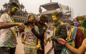 epa09102843 Nepalese youths smeared with colors during celebrations of Holi Festival amidst Coronavirus restrictions in Kathmandu, Nepal, 28 March 2021. Holi, also known as the Festival of Colors, marks the beginning of spring and is celebrated all over Nepal and neighboring India. Nepal government restricted to celebrate the Holi festival by gathering crowd and organizing party due to the spread of the coronavirus COVID-19 disease.  EPA/NARENDRA SHRESTHA