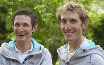 epa02830480 Leopard-Trek team rider Frank Schleck of Luxembourg (L) and Leopard-Trek team rider Andy Schleck of Luxembourg (R) speak to media during the second rest day of the Tour de France cycling race in Soyons, France, 18 July 2011.  EPA/IAN LANGSDON