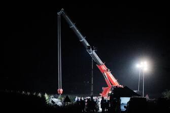 Rescuers remove the carcass of the car on which Laura Origliasso was traveling, the 5-year-old girl who lost her life when the car on which she was traveling home, along with her family, was involved in the crash of a Tricolor Arrow, near Turin, Italy, 16 September 2023.  (Frecce Tricolori bimba auto carcassa schianto Caselle)   ANSA / TINO ROMANO