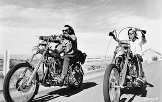 (Original Caption) Dennis Hopper (L) and Peter Fonda riding bikes in a scene from the movie Easy Rider. June 30, 1969.