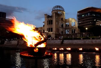 epa10786902 A bonfire is lightened past the A-bomb Dome to comfort victims of the 1945 atomic bombing at Hiroshima Peace Memorial Park in Hiroshima, Hiroshima Prefecture, western Japan, 05 August 2023 (issued 06 August 2023), the eve of the 78th anniversary of the atomic bombing. Hiroshima City has announced the toll of victims from the atomic bombing rose to about 140,000. The number of victims was counted as the end of 1945 after the August 6 bombing.  EPA/JIJI PRESS JAPAN OUT  EDITORIAL USE ONLY