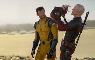 (L-R): Hugh Jackman as Wolverine/Logan, Dogpool, and Ryan Reynolds as Deadpool/Wade Wilson in 20th Century Studios/Marvel Studios' DEADPOOL & WOLVERINE. Photo by Jay Maidment. © 2024 20th Century Studios / © and ™ 2024 MARVEL.