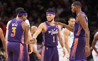 PHOENIX, ARIZONA - DECEMBER 29:  Devin Booker #1 of the Phoenix Suns celebrates with Bradley Beal #3 and Kevin Durant #35 after scoring against the Charlotte Hornetsduring the second half of the NBA game at Footprint Center on December 29, 2023 in Phoenix, Arizona. NOTE TO USER: User expressly acknowledges and agrees that, by downloading and or using this photograph, User is consenting to the terms and conditions of the Getty Images License Agreement.  (Photo by Christian Petersen/Getty Images)