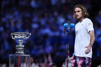 epa10438145 Stefanos Tsitsipas of Greece looks at the Norman Brookes Challenge Cup following his loss in the Men s Singles Final against Novak Djokovic of Serbia at the 2023 Australian Open tennis tournament in Melbourne, Australia, 29 January 2023.  EPA/JOEL CARRETT AUSTRALIA AND NEW ZEALAND OUT