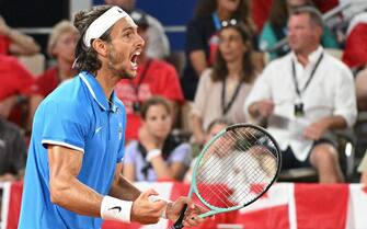 epa11523494 Lorenzo Musetti of Italy celebrates a point during the Men's Singles bronze medal match against  Felix Auger-Aliassime of Canada at the Tennis competitions in the Paris 2024 Olympic Games, at the Roland Garros in Paris, France, 03 August 2024.  EPA/CAROLINE BLUMBERG