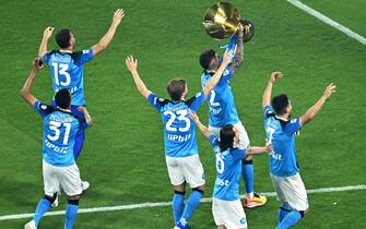 Napoli's Italian defender Giovanni Di Lorenzo (C-R) holds the Italian Scudetto Championship trophy as he and his teammates celebrate winning the 2023 Scudetto championship title on June 4, 2023, following the Italian Serie A football match between Napoli and Sampdoria at the Diego-Maradona stadium in Naples. (Photo by Tiziana FABI / AFP) (Photo by TIZIANA FABI/AFP via Getty Images)