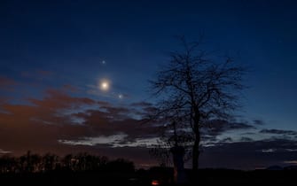 epa10484259 Planet Jupiter, the Moon (C) and planet Venus (R) observed on the sky photographed near Salgotarjan, Hungary, late 22 February 2023.  EPA/Peter Komka HUNGARY OUT