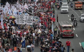 epa10765275 Activists stage a protest rally along a road leading to the Congress compound in Quezon city, Metro Manila, Philippines, 24 July 2023. The protesters gathered against the State of the Nation Address (SONA) of President Ferdinand 'Bongbong' Marcos.  EPA/FRANCIS R. MALASIG