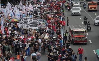 epa10765275 Activists stage a protest rally along a road leading to the Congress compound in Quezon city, Metro Manila, Philippines, 24 July 2023. The protesters gathered against the State of the Nation Address (SONA) of President Ferdinand 'Bongbong' Marcos.  EPA/FRANCIS R. MALASIG