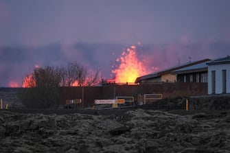 epa11077289 Lava explosions and rising smoke after a volcanic eruption near the town of Grindavik, in the Reykjanes peninsula, southwestern Iceland, 14 January 2024. A volcanic eruption began north of the town of Grindavik on the Reykjanes peninsula on 14 January, prompting authorities in Iceland to evacuate the small fishing town in the early morning as a precaution. The eruption is not expected to impact additional populated areas and does not present a 'threat to life', the Government of Iceland stated, adding that there are no disruptions to flights to and from Iceland. This is the second eruption in the area since December 2023, and the fifth since 2021.  EPA/ANTON BRINK