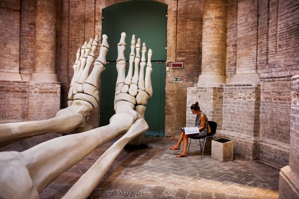 Steve McCurry, Donna legge vicino a una scultura. Foligno, Umbria, Italia, 2012 ©Steve McCurry