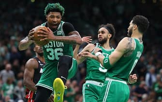 BOSTON, MASSACHUSETTS - MAY 25: Marcus Smart #36 of the Boston Celtics grabs a rebound ahead of Jimmy Butler #22 of the Miami Heat during the first quarter in game five of the Eastern Conference Finals at TD Garden on May 25, 2023 in Boston, Massachusetts. NOTE TO USER: User expressly acknowledges and agrees that, by downloading and or using this photograph, User is consenting to the terms and conditions of the Getty Images License Agreement. (Photo by Maddie Meyer/Getty Images)