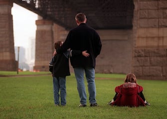 (AUSTRALIA OUT) A father stands under the Sydney Harbour with his two children, 25 July 1998. SMH Picture by BEN RUSHTON (Photo by Fairfax Media via Getty Images/Fairfax Media via Getty Images via Getty Images)