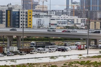 Vehicles drive through standing water on a highway after a rainstorm in Dubai, United Arab Emirates, on Tuesday, April 16, 2024. The United Arab Emirates experienced its heaviest downpour since records began in 1949, Dubai's media office said in a statement. Photographer: Christopher Pike/Bloomberg via Getty Images