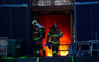 Firefighters work at the main entrance of the historic Boersen stock exchange building which is on fire in central Copenhagen, Denmark on April 16, 2024. The building, one of the oldest in the Danish capital, was undergoing renovation work when in the morning it caught fire, whose cause was yet unknown. The building was erected in the 1620s as a commercial building by King Christian IV and is located next to the Danish parliament. (Photo by Ida Marie Odgaard / Ritzau Scanpix / AFP) / Denmark OUT
