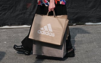 CENTRAL VALLEY, NY - AUGUST 26: A person carries a bag from the adidas store at the Woodbury Common Premium Outlets shopping mall on August 26, 2018 in Central Valley, New York. (Photo by Gary Hershorn/Getty Images)