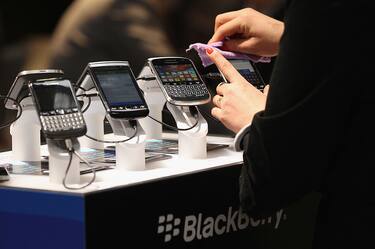 HANOVER, GERMANY - MARCH 06:  Visitors try out Blackberry smartphones at the Blackberry stand on the first day of the CeBIT 2012 technology trade fair on March 6, 2012 in Hanover, Germany. CeBIT 2012, the world's largest information technology trade fair, will run from March 6-10, and advances in cloud computing and security are major features this year.  (Photo by Sean Gallup/Getty Images)