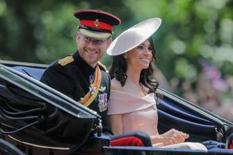 London, UK. 9th June 2018. HRH Prince Harry and his wife, Meghan, now titled the Duke and Duchdess of Sussex, ride in a horse drawn carriage in the procession along The Mall at Trooping the Colour, The Queens Birthday Parade. London.  This is Meghan, Duchess of Sussex first appearance at the procession. Credit: amanda rose/Alamy Live News