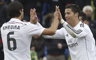 epa04566449 Real Madrid's Portuguese forward Cristiano Ronaldo (R) celebrates with German Sami Khedira after scoring the 0-3 for his team during their Spanish Primera Division League soccer match against Getafe at the Alonso Perez stadium in Getafe in the outskirts of Madrid, Spain, 18 January 2015.  EPA/Sergio Barrenechea