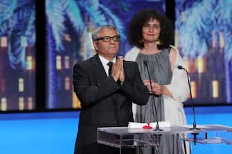 CANNES, FRANCE - MAY 25: Mohammad Rasoulof (L) receives the 'Special Award for Best Screenplay' for 'The Seed of the Sacred Fig' during the Closing Ceremony at the 77th annual Cannes Film Festival at Palais des Festivals on May 25, 2024 in Cannes, France. (Photo by Victor Boyko/Getty Images)