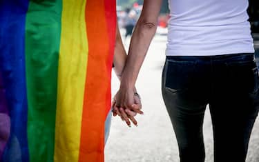 BUENOS AIRES, ARGENTINA - 2023/11/04: A couple walks hand in hand during the Argentina Pride Parade 2023,in Buenos Aires. (Photo by Roberto Tuero/SOPA Images/LightRocket via Getty Images)