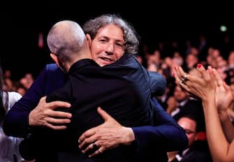 British director Jonathan Glazer (R) celebrates after he was awarded with the Grand Prix for the film "The Zone Of Interest" during the closing ceremony of the 76th edition of the Cannes Film Festival in Cannes, southern France, on May 27, 2023. (Photo by Valery HACHE / AFP) (Photo by VALERY HACHE/AFP via Getty Images)