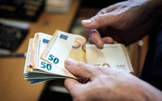 Counting cash-euro banknotes-fifty euros banknotes
