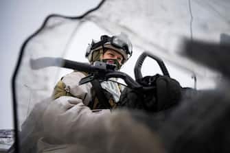 TOPSHOT - A soldier of the Jaeger Battalion GSV of the Norwegian Armed Forces that monitors the 196-kilometer-long border between Norway and Russia is pictured through a broken window on her snow scooter ahead of a demonstration of border crossing by Swedish and Finnish troops as part of the NATO Nordic Response 24 military exercise on March 9, 2024 on the Finnish side of the Kivilompolo border crossing between Finland and Norway, located above the Arctic Circle. Nordic Response 24 is part of the larger NATO exercise Steadfast Defender. The exercise involves air, sea, and land forces, with over 100 fighter jets, 50 ships, and over 20,000 troops practicing defensive manoeuvres in cold and harsh weather conditions. (Photo by Jonathan NACKSTRAND / AFP) (Photo by JONATHAN NACKSTRAND/AFP via Getty Images)