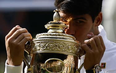 epa11477868 Carlos Alcaraz of Spain celebrates with his trophy after winning the Men's final against Novak Djokovic of Serbia at the Wimbledon Championships, Wimbledon, Britain, 14 July 2024.  EPA/TOLGA AKMEN  EDITORIAL USE ONLY