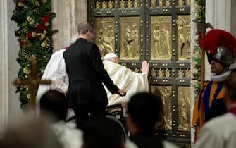 Pope Francis opens the Holy Door to mark the opening of the 2025 Catholic Holy Year, or Jubilee, in St. Peter's Basilica, at the Vatican, December 24, 2024. REUTERS/Remo Casilli/Pool