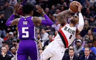 SACRAMENTO, CALIFORNIA - JANUARY 14:  Damian Lillard #0 of the Portland Trail Blazers is fouled by De'Aaron Fox #5 of the Sacramento Kings as he shoots the ball at Golden 1 Center on January 14, 2019 in Sacramento, California. NOTE TO USER: User expressly acknowledges and agrees that, by downloading and or using this photograph, User is consenting to the terms and conditions of the Getty Images License Agreement. (Photo by Ezra Shaw/Getty Images)